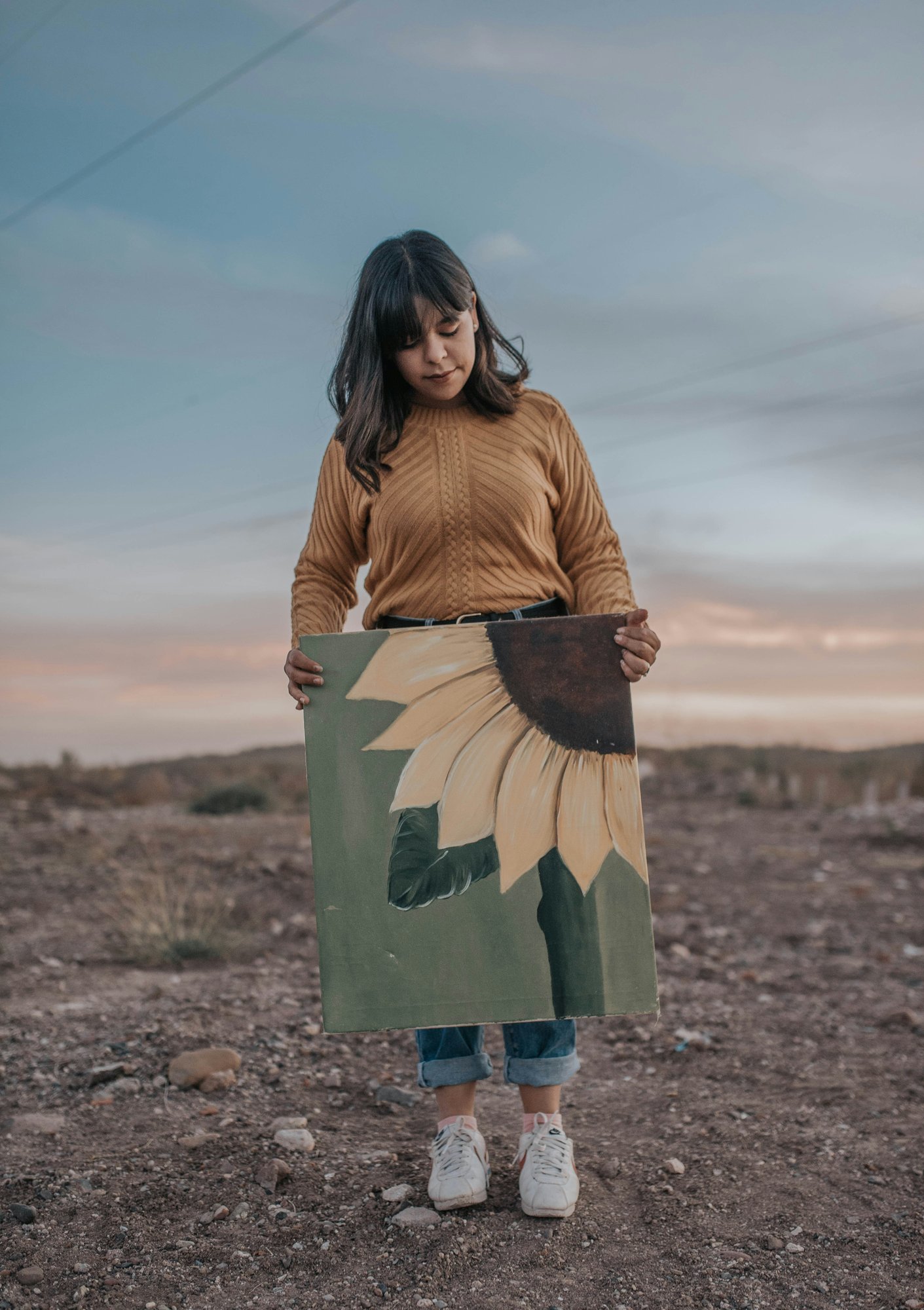 student with sunflower